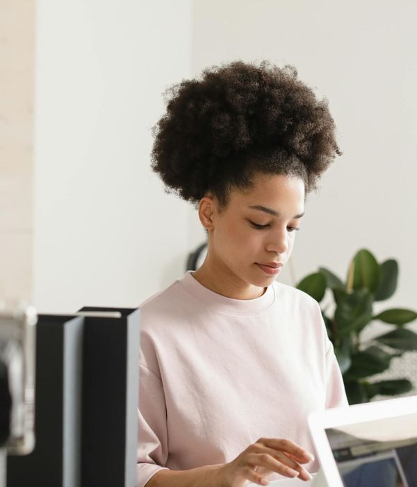 Woman with a serene expression, focusing her eyes, with cyan light effects around her.